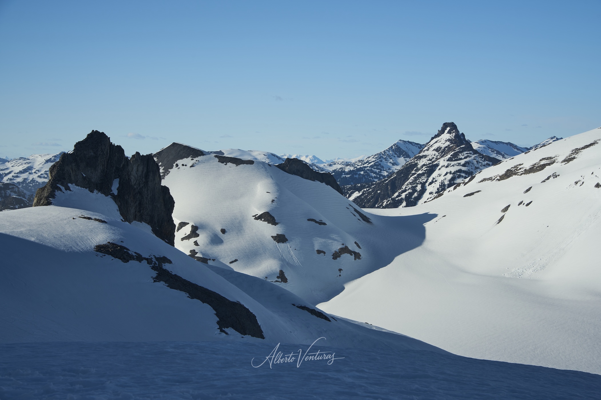 Tienda de campaña montada sobre el glaciar, con el atardecer iluminando los picos